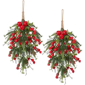Professional view of two Christmas teardrop swags with red berries and pine branches