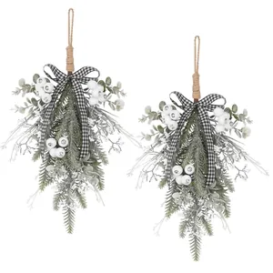 Pair of Christmas teardrop swags with frosted greenery and checkered bow.