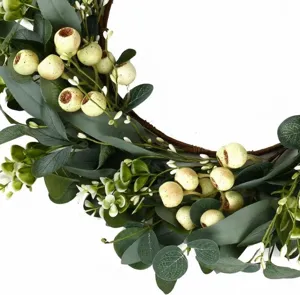 Macro detail of artificial eucalyptus wreath with white berries and vine base