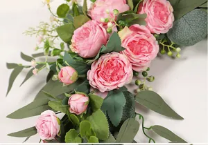 Detailed macro view of pink artificial roses and green eucalyptus leaves for wedding sign decoration