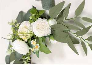 Detailed view of artificial white peony and eucalyptus greenery floral arrangement for wedding