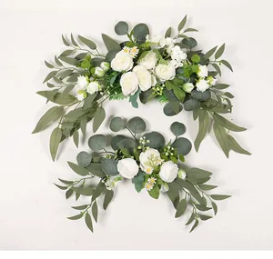 Elegant artificial white roses and eucalyptus leaves arrangement for wedding signs