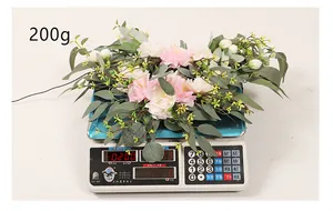 Detailed view of the artificial flower arrangement on a scale weighing 200g