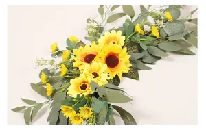 Close-up detail of artificial sunflower and eucalyptus floral swag for wedding decor