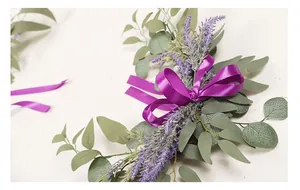 Detailed view of artificial lavender and eucalyptus wreath with a vibrant purple silk bow