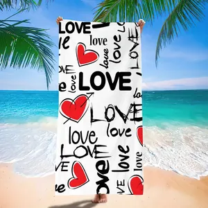 Macro detail of microfiber quick-dry beach towel featuring red heart and LOVE typography