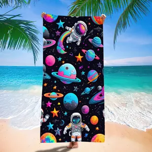 Detail view of colorful astronaut and planet print on quick-dry microfiber beach towel