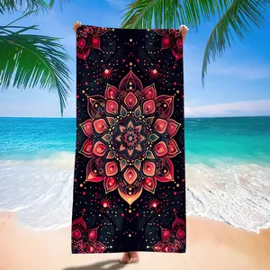 Detailed view of microfiber mandala beach towel held against a tropical beach backdrop