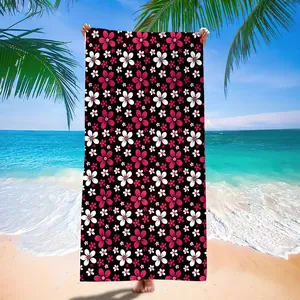 Detailed view of quick-dry microfiber beach towel with vibrant pink floral mandala pattern