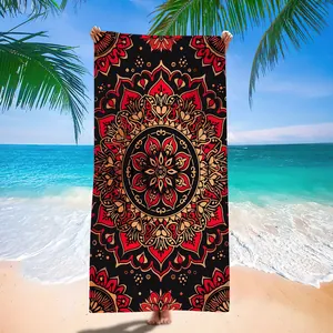 Red and black mandala print quick-dry microfiber beach towel shown in beach setting