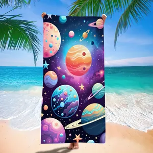 Detailed view of microfiber beach towel with vibrant outer space and colorful planets print.
