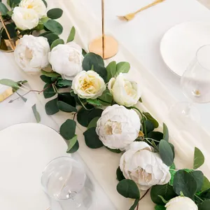 Elegant detail of artificial peony and eucalyptus flower garland for wedding table decoration