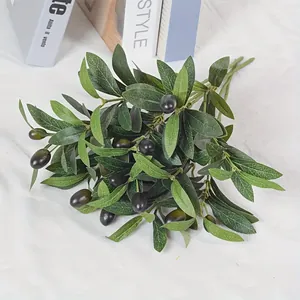 Detailed view of artificial olive branch with realistic dark green leaves and fruits
