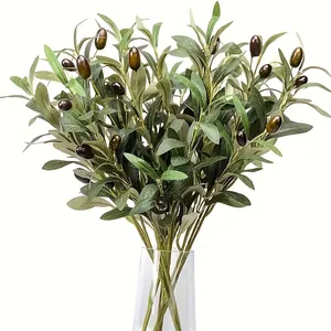 Close-up of realistic artificial olive branches with green leaves and dark fruits