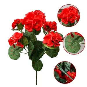 Macro detail view of artificial red geranium silk flower petals, leaves and stem texture