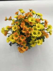 Vibrant yellow and orange artificial daisy flowers in a black iron hanging basket