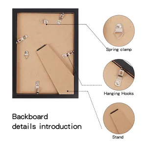 Backboard details of a wooden photo frame showing spring clamps and hanging hooks