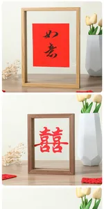 Close-up of double-sided glass wooden frame showing traditional paper cutting detail