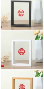Macro view of minimalist double-sided glass frames in black, white, and wood finish.