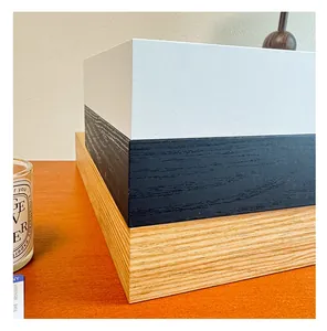 Detail view of stacked wooden ticket storage frames in white, black, and natural wood textures.