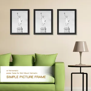 Set of three black poster frames mounted vertically in a modern living room scene.
