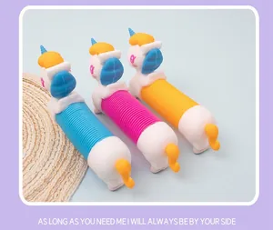 Three colorful silicone pop tube unicorn toys in blue pink and yellow colors