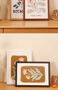 Detail view of modern wooden photo frames in natural, dark brown, white, and black finishes
