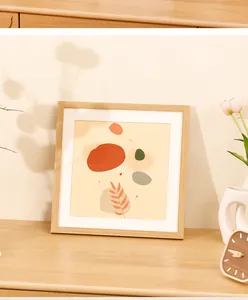 Modern square light wood picture frame displaying abstract art in a warm minimalist home setting