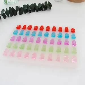 Close-up of small colorful resin gummy bears inside a 50-cavity silicone DIY mold