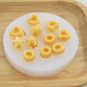 Close-up of silicone mold featuring cereal, star, and heart shapes for DIY crafts