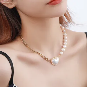 Elegant gold chain and pearl heart pendant necklace shown on an Asian female model.
