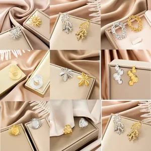 Elegant irregular stainless steel stud earrings available in gold and silver finishes
