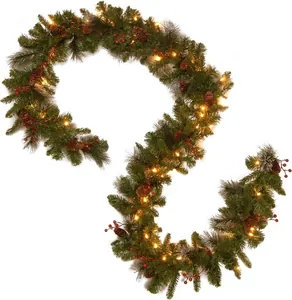 Detail of pre-lit Christmas garland with pine cones and red berries on white background