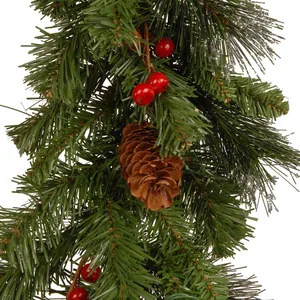 Close-up of Christmas garland with realistic pine needles, red berries and pinecone