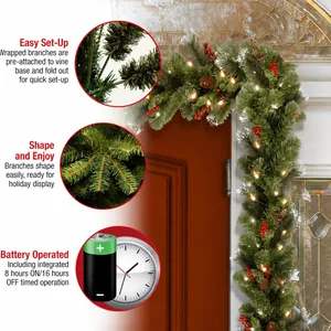Pre-lit Christmas pine garland with pinecones and berries for holiday door decoration.