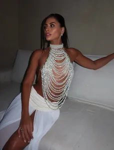 Detailed view of elegant multi-layer pearl halter top with handmade chain design