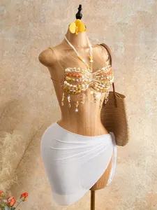 Detailed view of bohemian handmade beaded halter top featuring sparkling crystal tassels