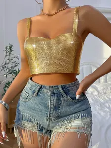 Detail view of a sexy gold metallic sequin crop top paired with fringed denim shorts.