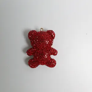 Macro detail of a sparkling red rhinestone-encrusted bear pendant for keychains