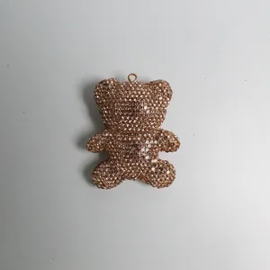 Close-up view of a rose gold rhinestone teddy bear keychain pendant