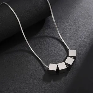 Minimalist titanium steel necklace with five silver cube pendants on a sleek snake chain