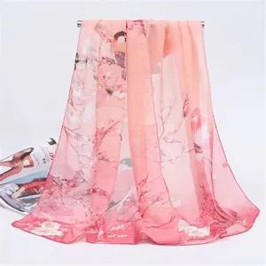 Lightweight pink chiffon scarf featuring elegant magpie and floral spring pattern detail.