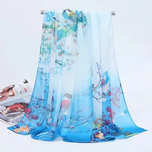 Detailed view of a blue gradient chiffon scarf with magpie and floral prints