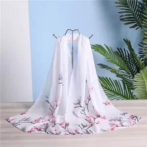 Detail view showing the soft texture and floral print of the white chiffon scarf for women