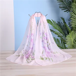 Detailed visual of a lightweight light pink floral chiffon scarf draped on a display stand.