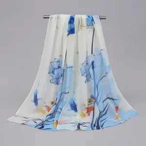 Detail view of the long chiffon scarf with elegant lotus and koi fish pattern