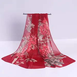 Elegant red chiffon long scarf featuring vivid peony floral prints and soft texture.