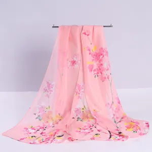 Detailed view of pink chiffon scarf with vibrant floral blossom print pattern