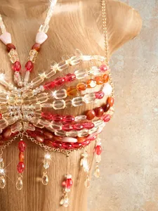 Detailed macro view of bohemian handmade beaded halter top featuring colorful fringe tassels