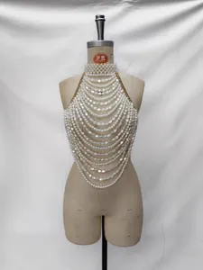 Elegant multi-layer pearl halter top vest with gold chain straps shown on mannequin